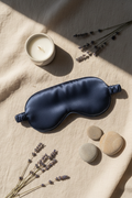 Aldera DreamEase Sleep Mask on cream linen with lavender and candle